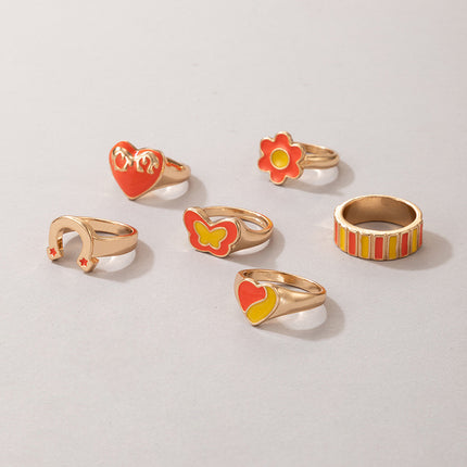 Juego de seis piezas de anillos de goteo de color de mariposa con cuentas de arroz Love Flower